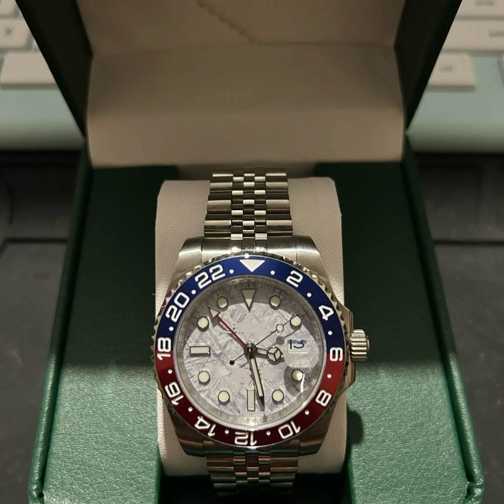 Luxury Silver Watch with Red and Blue Bezel